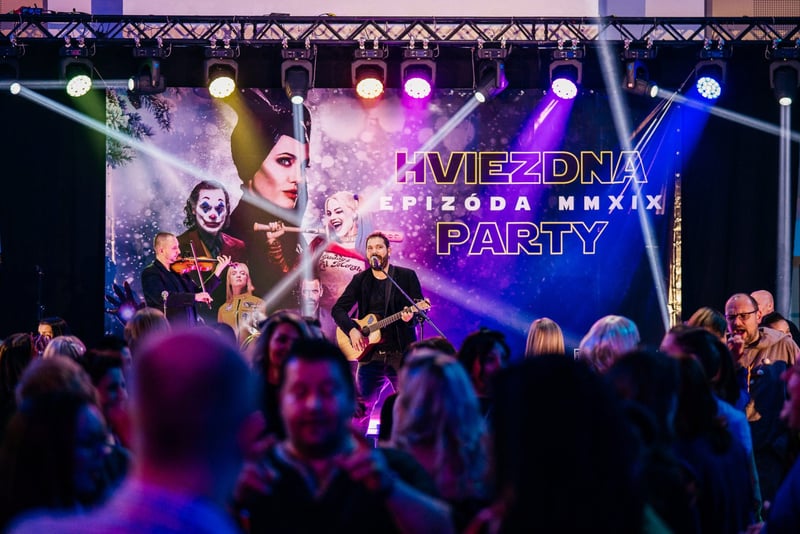 Kostýmovaná firemná party s LED scénou, kapelou a tancujúcim publikom v popredí